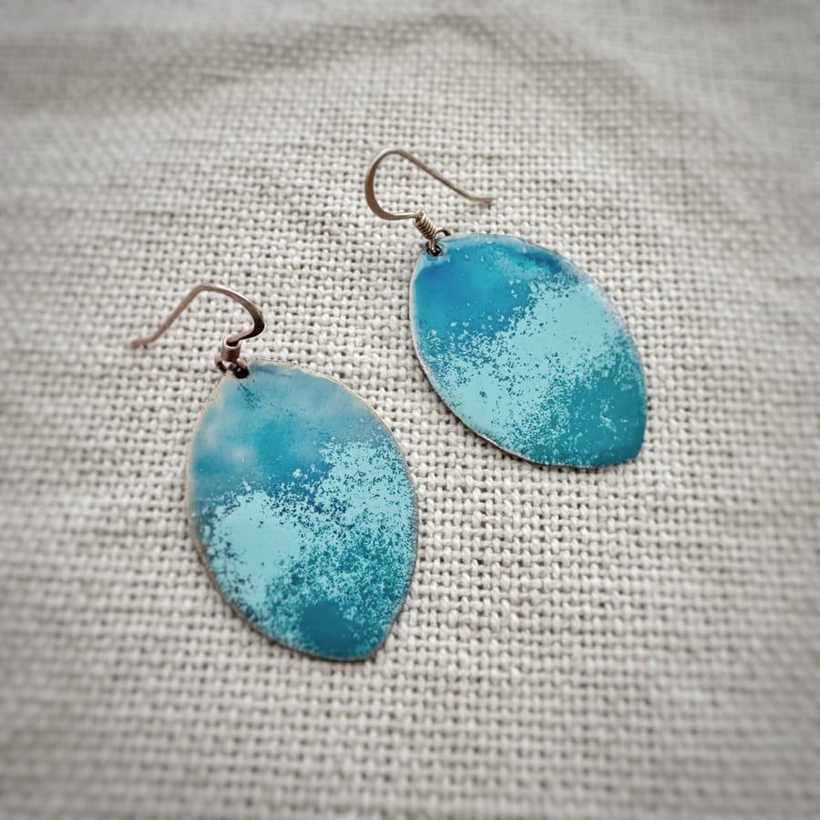 Handcrafted turquoise leaf earrings made with copper, low-temperature enamels and sterling silver hooks.